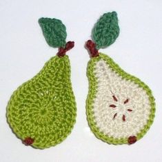 two crocheted pears with green leaves on them