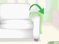 a white chair with a green blanket on it's back and an arrow pointing to the right