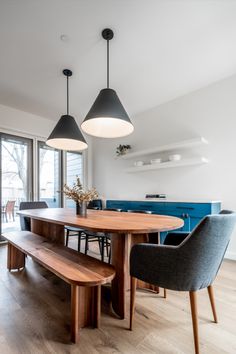 a dining room table with two benches next to it