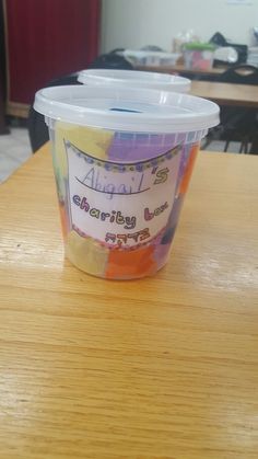 a plastic cup sitting on top of a wooden table