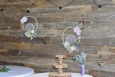 the table is set up with flowers and candles on it, along with other decorations