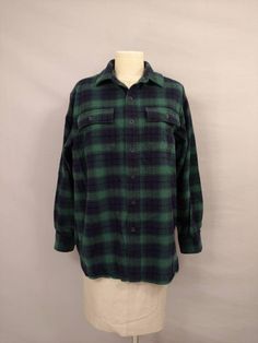 "Classic comfortable casual style in a heavy weight plaid soft cotton fabric. Very traditional check plaid in green, dark blue and black. Quality construction and fabric. Well made and well cared for. Nice piece for casual wear and layering. Good choice for a chilly evening or a crisp day hike. Size says M Reg, please go by measurements. Condition very good, no damage or excessive wear. Button front, two chest patch pockets with button flaps. Has curving hemline. Label is L L Bean. Length 31.5\" Chamois Shirt, Full Length Coat, Classic Preppy, Saint Patrick's Day, Day Hike, Green Dark, Green Plaid, Costume Dress, L L Bean