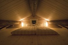 there is a bed in the middle of an attic