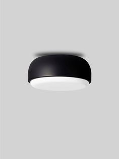 a black ceiling light on a gray wall