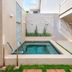 a small swimming pool in the middle of a patio with stairs leading up to it