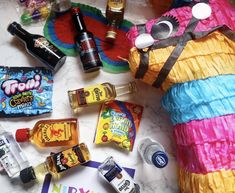 a table topped with candy, candies and other items to make a paper mache