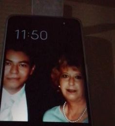 an older woman and young man are shown on the back of a cell phone screen