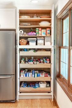 an organized pantry in a kitchen with stainless steel refrigerator and dishwasher next to it