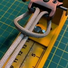 a close up of a piece of equipment on a cutting board with scissors and tape