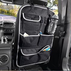 the interior of a vehicle with an open car door and various items hanging from it