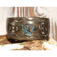 For your consideration is this wonderful vintage Navajo Sterling Silver Bracelet. This timeless piece showcases intricate tribal design turquoise and coral inlay within an ingot hand-stamped design, reflecting the rich heritage of Navajo craftsmanship. Measuring approximately 1" in width, it offers a perfect blend of elegance and cultural significance. With a wrist size range of 6-7" including an opening. Embrace the spirit of Navajo artistry with this extraordinary bracelet. Traditional Hand Tooled Turquoise Jewelry, Traditional Hand-tooled Turquoise Jewelry, Traditional Stamped Turquoise Jewelry, Antique Stamped Turquoise Jewelry, Traditional Engraved Turquoise Bracelets, Traditional Adjustable Jewelry With Patina, Traditional Turquoise Engraved Bracelet, Traditional Turquoise Bracelet With Inlay, Vintage Turquoise Bracelets With Hand Tooling