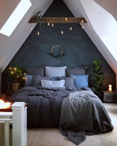 a bedroom with a bed and some lights on the wall above it in an attic