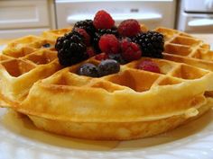 a waffle topped with berries and blueberries on a plate