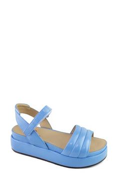 A chunky platform and slight wedge heel elevate a glossy leather sandal secured with an adjustable strap at the ankle. 1 1/2" heel Adjustable ankle strap with hook-and-loop closure Leather upper and lining/rubber sole Made in Brazil Blue Wedge Sandals With Buckle Closure, Modern Blue Ankle Strap Sandals, Blue Synthetic Wedge Sandals With Heel Strap, Blue Leather Wedge Sandals With Ankle Strap, Blue Leather Ankle Strap Slingback Sandals, Blue Platform Wedge Sandals With Ankle Strap, Blue Ankle Strap Wedge Sandals With Removable Insole, Platform Wedge Sandals, Chunky Platform