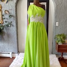 Beautiful Embellished Chartreuse Evening Gown Will Have All Eyes On You Throughout The Evening. Never Worn With Tags Still Attached. This Is A Yishaer Wedding Dress. But This Dress Can Be Worn For Any Special Event You Might Want To Look Fantastic For. One Shouldered Dress With A Full Coverage Bodice, One Crossover Back Strap And A Lovely Scarf That Drapes From The Right Should Down The Back. Hidden Zipper. This Dress Is A Beauty And In Perfect Condition. Green Evening Dress With Sweep Train For Homecoming, Green Homecoming Evening Dress With Sweep Train, Green Gown With Sweep Train For Homecoming, Green Homecoming Gown With Sweep Train, Floor-length Embellished Gown For Homecoming, Green Floor-length Evening Dress For Homecoming, Green Bridesmaid Gown For Prom Season, Glamorous Green Gown For Homecoming, Green Floor-length Gown For Homecoming