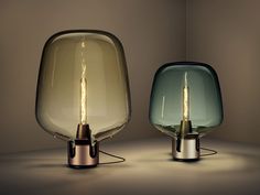 two different colored lamps sitting next to each other