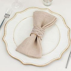 a white plate topped with a napkin and silverware