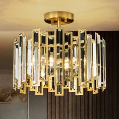 a modern chandelier hanging from the ceiling in a living room or dining room