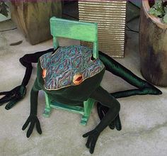 a frog sitting on top of a green chair