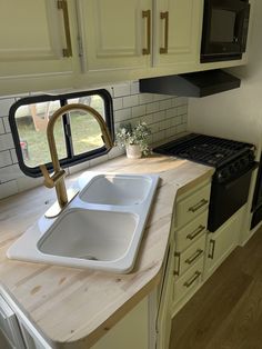 a kitchen counter with a sink and oven