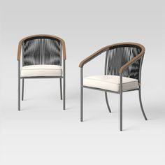 two chairs with armrests and seat cushions