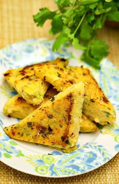 three pieces of food on a plate with parsley in the backgroung