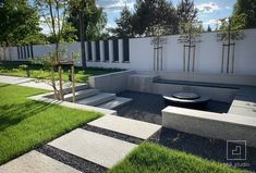 a modern garden with grass and stepping stones