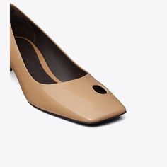 The classic pump is reimagined with modern twists, featuring an angled kitten heel and a square-toe with a single cut-out. Subtle yet striking, it is crafted in patent leather. Modern Square Toe Kitten Heels With Sculpted Heel, Metallic Clutch, Wrap Heels, Kitten Heel Pumps, Classic Pumps, Footwear Design Women, Designer Heels, Kitten Heel, Leather Wraps