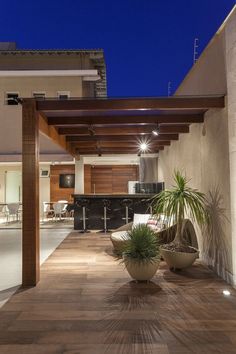 an outdoor living area with potted plants and lights