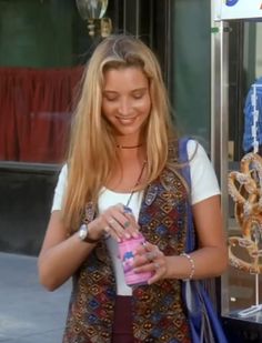 a woman is holding a pink bottle and smiling