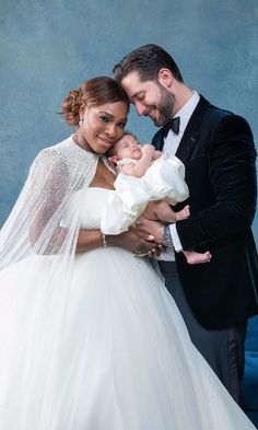 a man in a tuxedo and woman in a wedding dress holding a baby