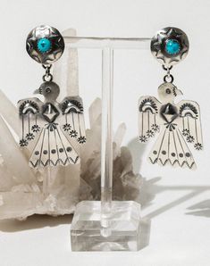 Handcrafted Native American sterling thunderbird earrings. These earrings feature unique traditional stamping, repoussé, and beautiful turquoise adornments. The great thunderbird is a spirit well-known throughout Native American culture. The bird is seen as the most powerful of all spirits and has the ability to shapeshift into human form. Porcupine Quill Jewelry, Native American Thunderbird, Vintage Native American Jewelry, Native American Earrings, Turquoise Jewelry Native American, Human Form, Jewelry Antique, American Culture, Cow Skull