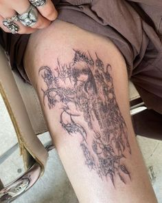 a woman's legs with tattoos on them