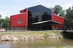 a large red building sitting next to a river