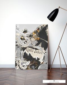 a painting on the wall next to a floor lamp and a black and white poster