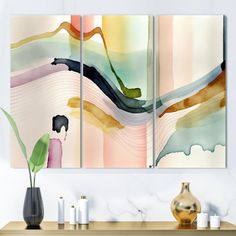 three abstract paintings on a wall above a table with vases and other items in front of it