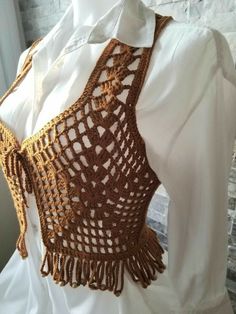 a crocheted halter top on a mannequin's torso is shown