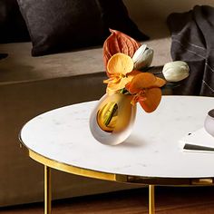 a vase with flowers on a table in a living room