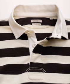 Rugby stripes lend a timeless, athletic appeal to this soft, cotton-jersey polo. Underarm embroidered grommets provide better ventilation and comfort, while the vintage-inspired interior ID label awaits your name or initials. 100% cotton jersey Garment-washed Natural color twill collar and placket Covered placket with rubber buttons Underarm embroidered grommets Signature flag tape on side seam Vintage inspired interior ID label Machine wash cold Imported Classic Striped Polo Shirt, White Polo Collar Top With Striped Cuffs, Cotton Polo Shirt With Striped Cuffs, Sporty Cotton Tops With Vertical Stripes, Classic Long Sleeve Polo Shirt With Contrast Stripes, Classic Three Stripes Polo Shirt, Classic Three-stripes Polo Shirt, White Polo Shirt With Horizontal Stripes, White Cotton Polo Shirt With Striped Collar