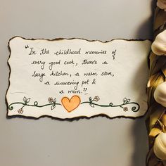 a piece of paper with a poem written on it next to some flowers and leaves