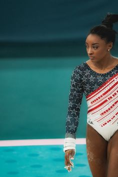 a woman standing on top of a swimming pool