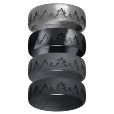 three rings with trees on them are stacked up in front of each other, and one is