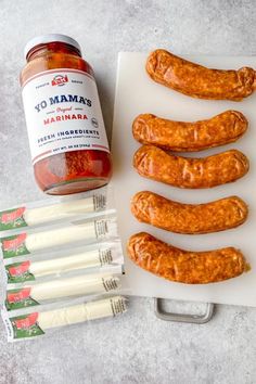 the ingredients for sausages are laid out on a cutting board and ready to be cooked