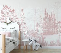 a bedroom with pink and white wallpaper that has a forest scene on the wall