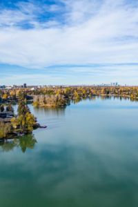 an aerial view of a lake surrounded by trees