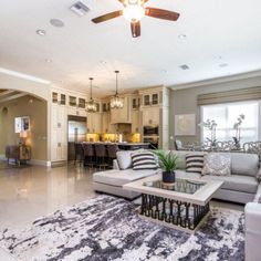 a living room filled with furniture and a ceiling fan