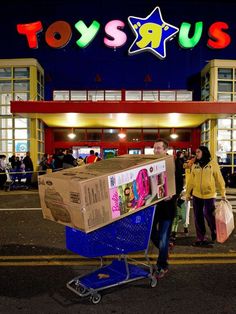 a person pushing a cart with toys r us on it