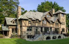 this is an image of a large house in the country side with stone and brick accents