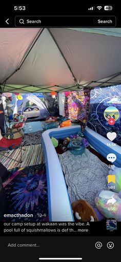 the inside of a tent with an inflatable bed and other items on it