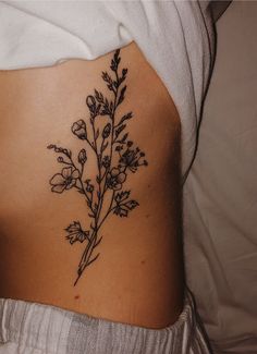 the back of a woman's stomach with flowers on it